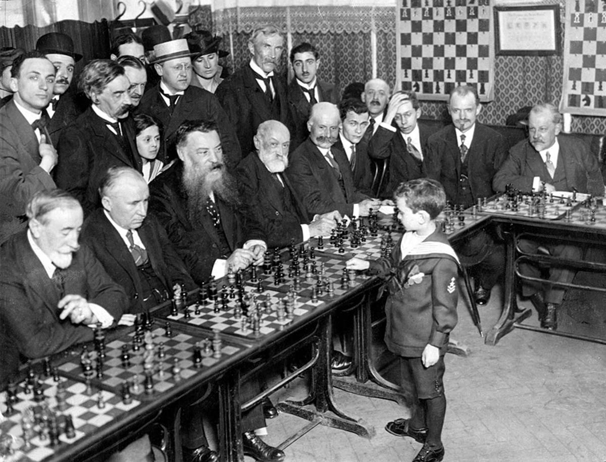 Reshevsky, age 8, giving a simultaneous chess exhibition in France, 1920. (Wikimedia)