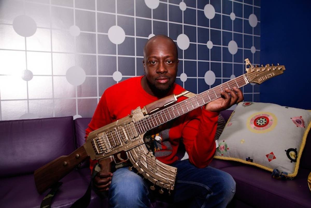 Wyclef Jen poses backstage with a guitar shaped like a AK-47 before taping a segment on BET's 106 & Park on May 1, 2013 in New York City.(Getty)