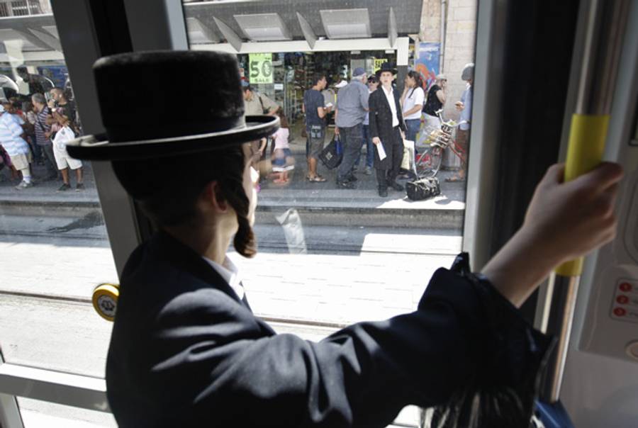 An ultra-Orthodox man on Jerusalem's light rail system, August 2011.(Ahmad Gharabli/AFP/Getty Images)