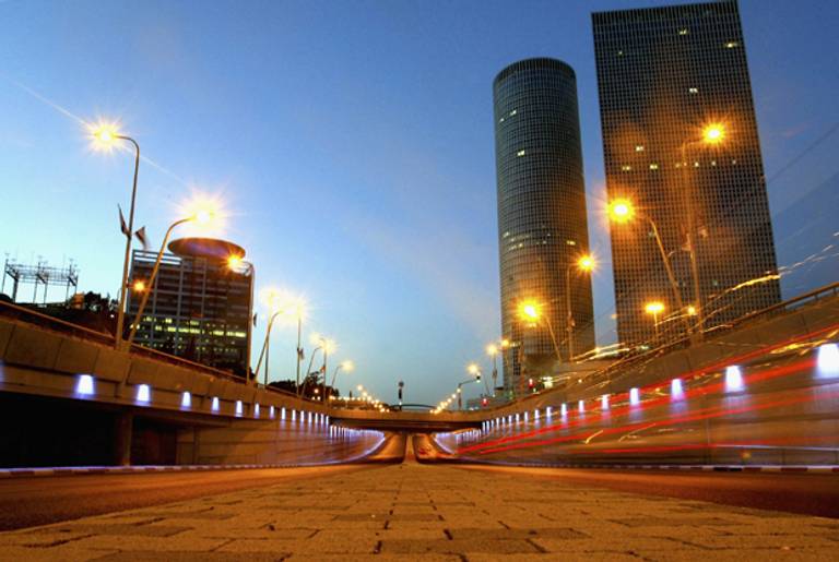Cars go by on a highway next to Tel Aviv's landmark Azrieli Towers skyscraper complex on May 28, 2004 in Tel Aviv, Israel.(Uriel Sinai/Getty Images)