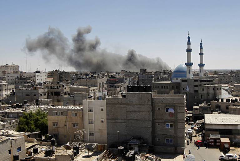 Smoke billows from a building hit by an Israeli air strike in the town of Rafah, in the southern Gaza Strip, on July 14, 2014. (SAID KHATIB/AFP/Getty Images)