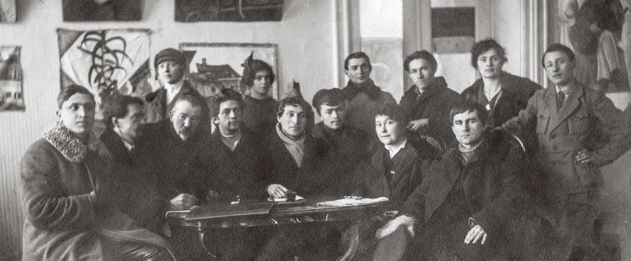 Members of the Creative Committee of the People’s Art School, Vitebsk, winter 1919.  Seated: Yuri (Yehuda) Pen (third from left), Marc Chagall (center), Vera Ermolaeva (second from right), Kazimir Malevich (right).