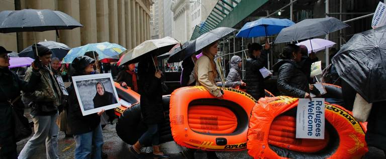 People carry rafts as they take part in a protest against the U.S. refugee ban outside The Trump Building  in New York City, March 28, 2017.
