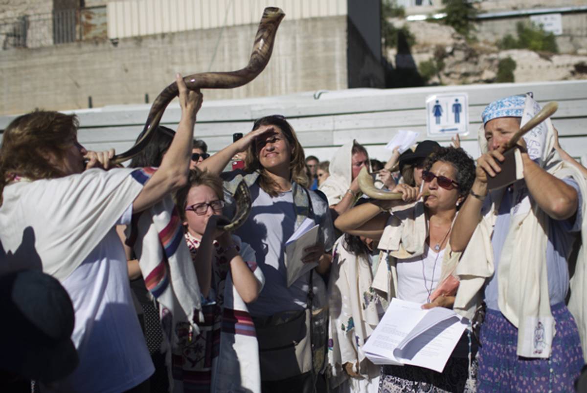 Members of the liberal Jewish religious group Women of the Wall blow the Shofar as they pray at the plaza near the Western Wall, Judaism's holiest site, in Jerusalem's Old City on August 7, 2013, marking the first day of the Jewish month of Elul. (MENAHEM KAHANA/AFP/Getty Images)
