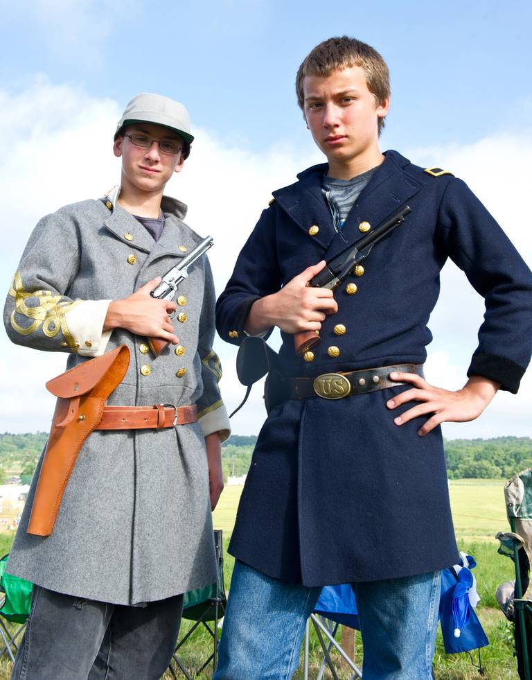 Civil War reenactors, brothers Chandler (Union) and Chase (Confederate) Moore from Columbia, Illinois, pose with their pistols at the 150th Gettysburg celebration and reenactment in Gettysburg, Pennsylvania, July 5, 2013