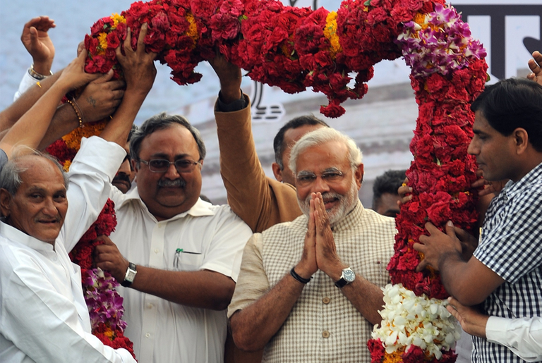 Narendra Modi (second from right) is garlanded as he arrives at a public rally after his victory in Vadodara on May 16, 2014. (Indranil Mukherjee/AFP/Getty Images)