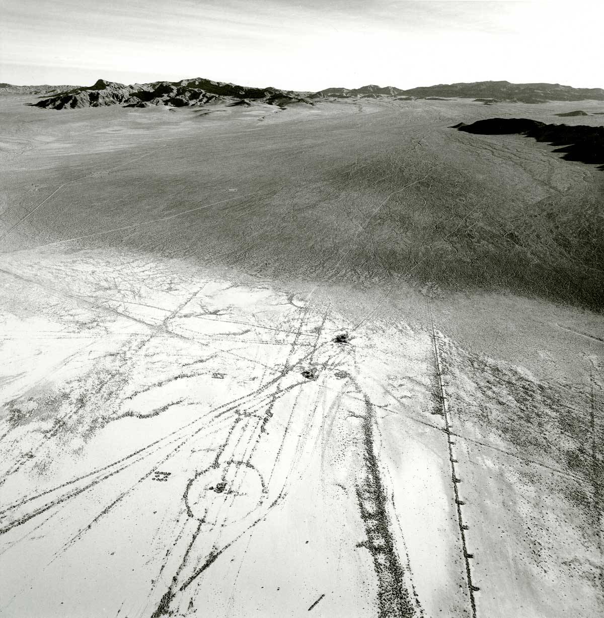Emmet Gowin, THE EASTERN EDGE OF FRENCHMAN FLAT SHOWING THE TRANSITION FROM ALLUVIAL WASH TO DRY LAKE BED, LOOKING EAST, AREA 6, NEVADA TEST SITE, 1997. (From THE NEVADA TEST SITE by Emmet Gowin, with a foreword by Robert Adams, Princeton University Press, 2019.)