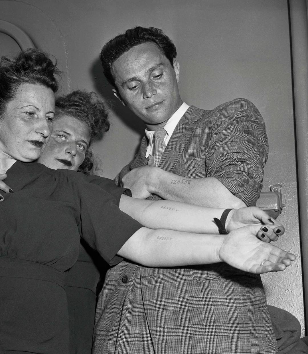 Three Holocaust survivors newly arrived in New York, after being liberated in Wiesbaden, Germany, and traveling via the SS Marine Flasher out of Bremenhaven. Mother and daughter Else and Rita Springut, and Moses Fish, 1946.