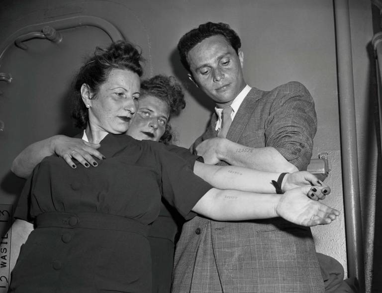 Three Holocaust survivors newly arrived in New York, after being liberated in Wiesbaden, Germany, and traveling via the SS Marine Flasher out of Bremenhaven. Mother and daughter Else and Rita Springut, and Moses Fish, 1946.