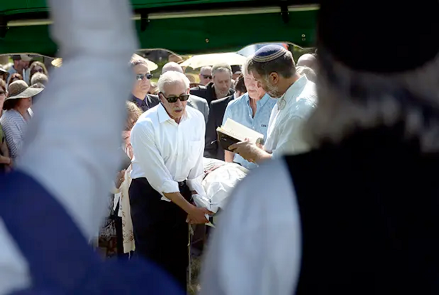 The body of Rabbi Zalman Schachter-Shalomi is carried up a hill during a funeral service at Green Mountain Cemetery in Boulder on Friday July 4, 2014.