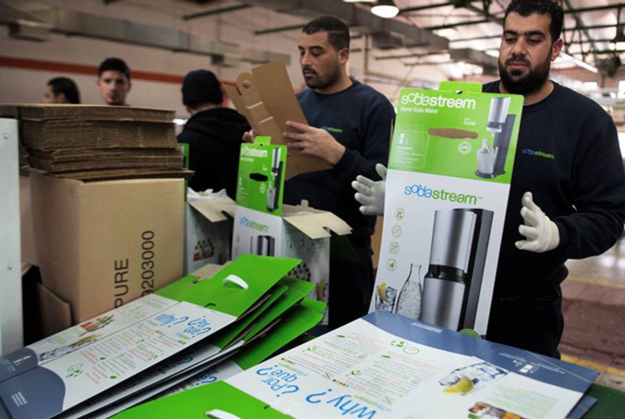 Palestinian workers prepare boxes to pack products at the Israeli SodaStream factory in the Mishor Adumim industrial park, next to the West Bank settlement of Maale Adumim on January 30, 2014. (MENAHEM KAHANA/AFP/Getty Images)