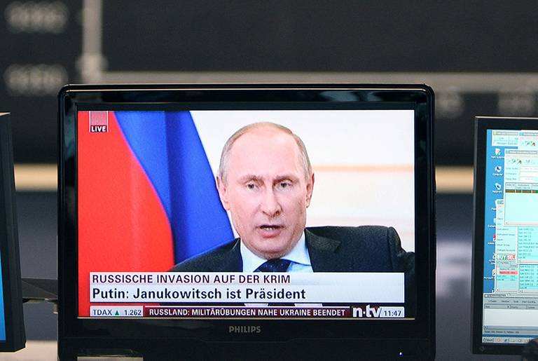 A TV screen showing Russian President Vladimir Putin is pictured at the stock exchange in Frankfurt, Germany, March 4, 2014.(Daniel Roland/AFP/Getty Images)