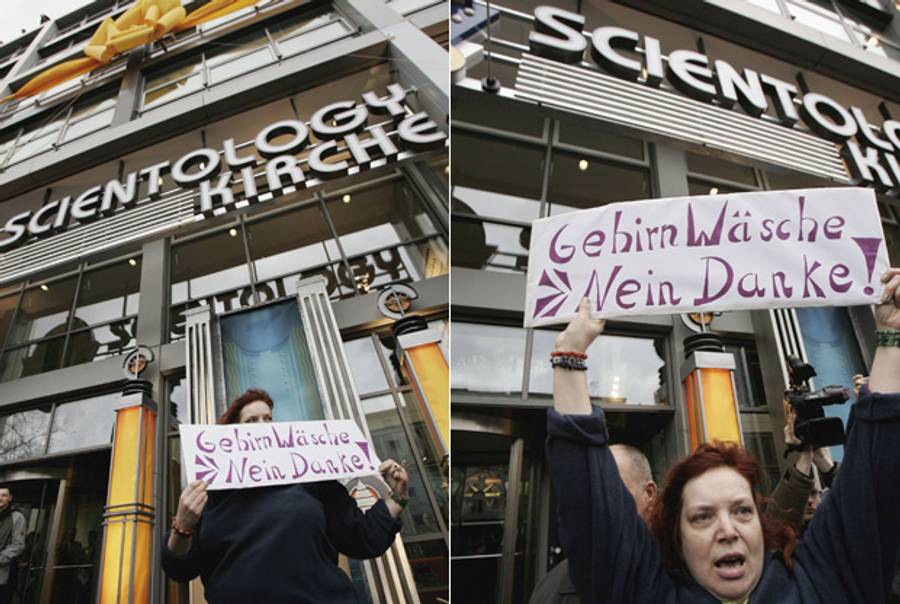 A woman holds a sign that reads "Brainwashing, No thank you!" in front of the Scientology Church and center on its official opening day Jan. 13, 2007, in Berlin. (Sean Gallup/Getty Images)