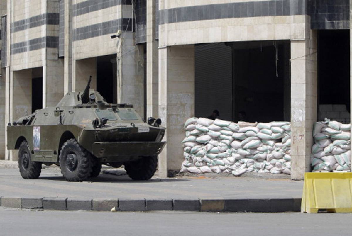 A Syrian tank on a residential street in Homs.(Joseph Eid/AFP/Getty Images)