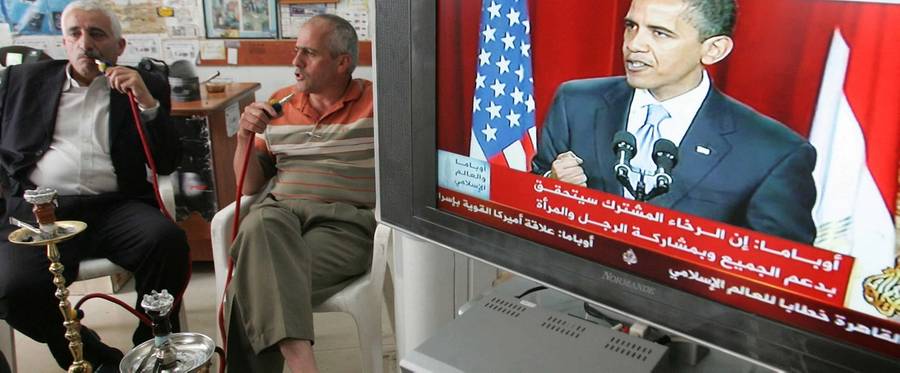 Palestinians smoke waterpipes as they listen to US President Barack Obama's speech at Cairo University, at a shop in the West Bank city of Hebron on June 4, 2009. Obama reitererated US support for a Palestinian state living in peace with Israel, calling on Palestinians to renounce violence and on Israel to put an end to settlements.