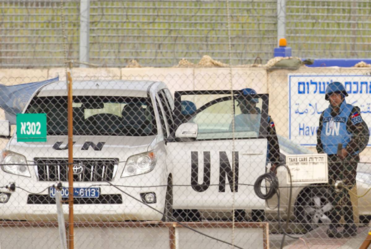 UN peacekeepers cross the Quneitra checkpoint between Israel and Syria in the Golan Heights on March 07, 2013. (JACK GUEZ/AFP/Getty Images)