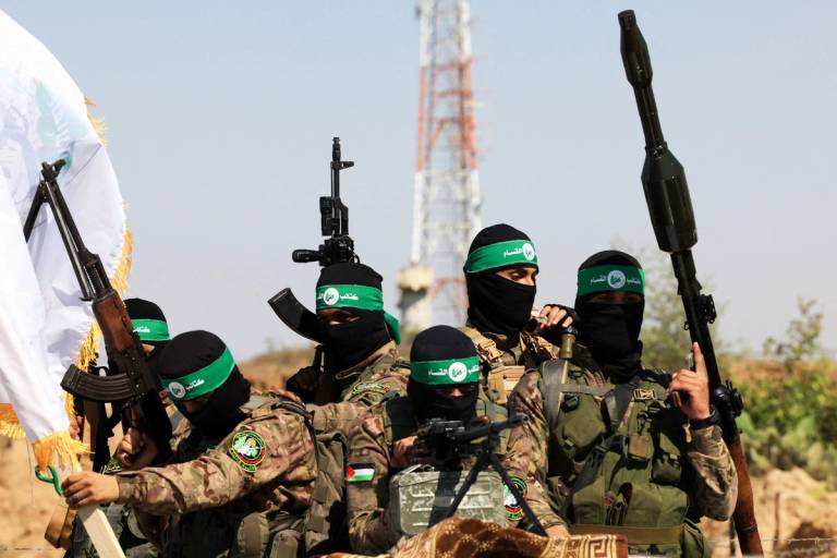 Palestinian fighters of the al-Qassam Brigades, the armed wing of the Hamas movement, take part in a military parade to mark the anniversary of the 2014 war with Israel, near the border in the central Gaza Strip on July 19, 2023