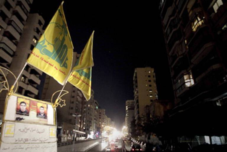 Hezbollah flags fly in Beirut last night.(Joseph Eid/AFP/Getty Images)
