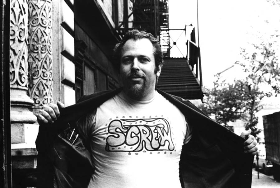 Portrait of American pornographic magazine publisher Al Goldstein as he holds open his jacket to reveal a t-shirt that bares the name of his publication, 'Screw,' New York, New York, June 26, 1969. (Fred W. McDarrah/Getty Images)