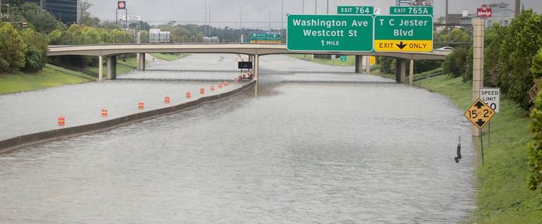 Water flows down Interstate 10 which has been inundated with flooding from Hurricane Harvey on August 27, 2017 in Houston, Texas.