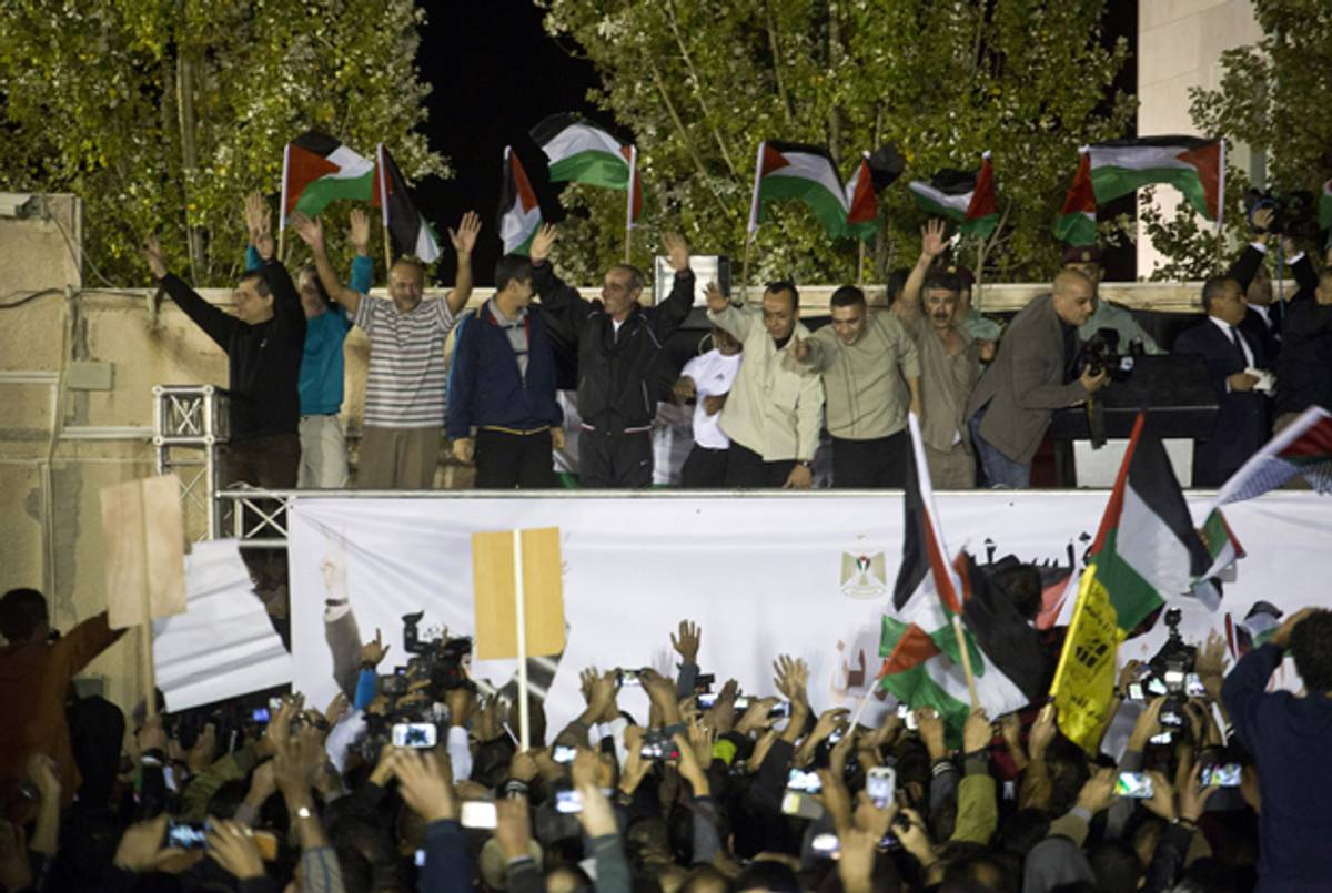 Released Palestinian prisoners stand on a sage as they arrive to the Mukata Presidential Compound in the early morning hours on October 30, 2013 in Ramallah, West Bank. (Oren Ziv/Getty Images)