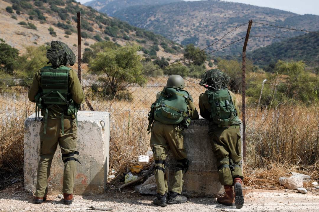 Israeli soldiers take positions near the Israeli military base of Har Dov on Mount Hermon, a strategic and fortified outpost at the crossroads between Israel, Lebanon, and Syria, on Oct. 10, 2023