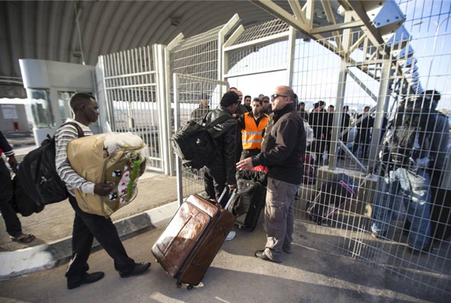African asylum seekers, who entered Israel illegally via Egypt, enter the Holot detention centre in Israel's southern Negev Desert, on February 17, 2014. (JACK GUEZ/AFP/Getty Images)