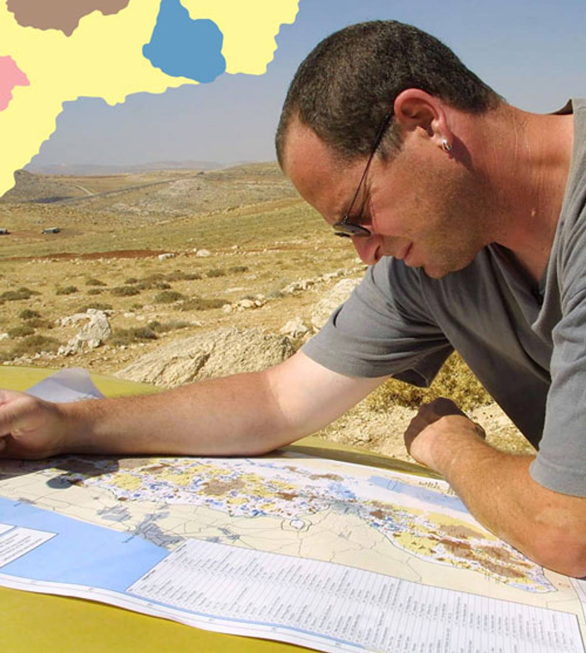 Dror Etkes, head of the Peace Now Settlement Watch team, checks a map as he monitors new illegal outposts in the Kohav Hashachar area in 2003 (Photo: Quique Kierszenbaum/Getty Images)