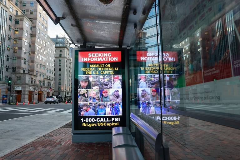 An electronic advertisement not far from the White House shows the faces of suspects who assaulted federal officers at the Capitol Building during the Jan. 6, 2021, storming
