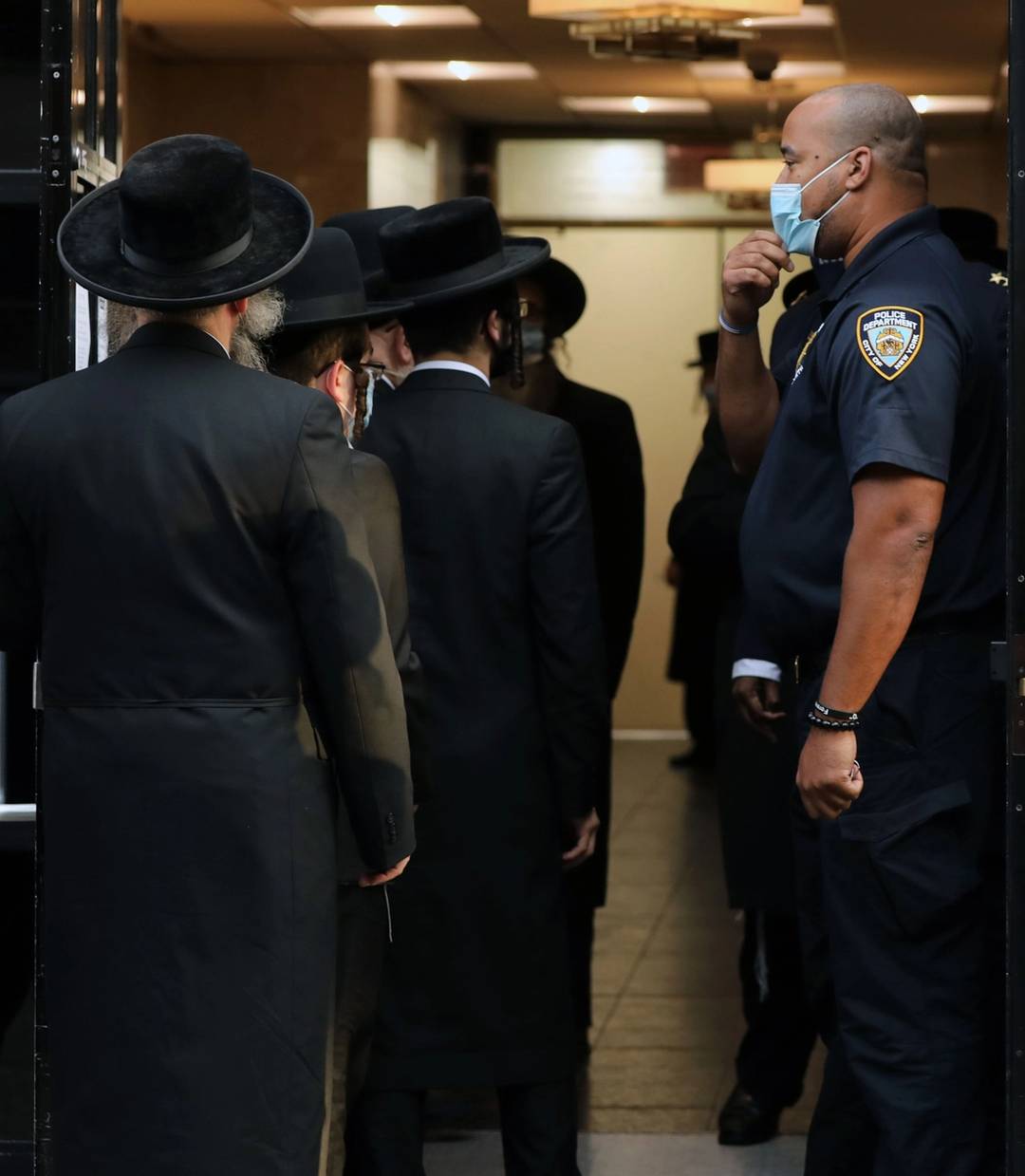 People congregate outside of the Congregation Yetev Lev D'Satmar synagogue on Oct. 19, 2020, in Brooklyn's Williamsburg neighborhood. A wedding planned for a grandchild of Zalman Leib Teitelbaum, a grand rabbi of the Satmar sect, was ordered to be shut down after New York City authorities were alerted that the event could draw as many as 10,000 celebrants to Williamsburg during a COVID-19 outbreak in the community.