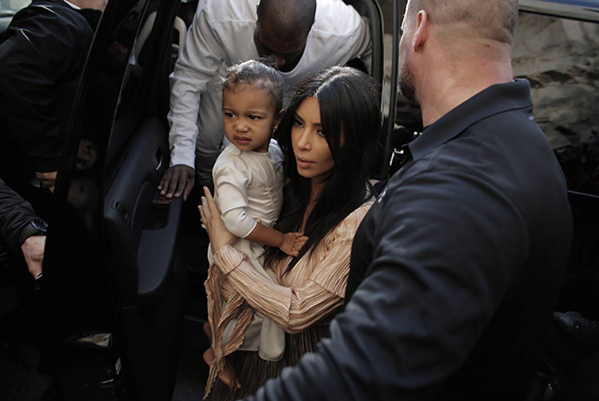 Kim Kardashian carries daughter North West as she and husband Kanye West arrive at the Armenian St. James Cathedral in Jerusalem's Old City on April 13, 2015. (Ahmad Gharabli/AFP/Getty Images)