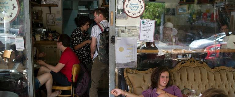 Customers sit at Jerusalem's Carousela restaurant, supervised by "Hashgaha Pratit" (Hebrew for "private supervision"), which certifies that the restaurant abides by kosher practices. June 8, 2016. 