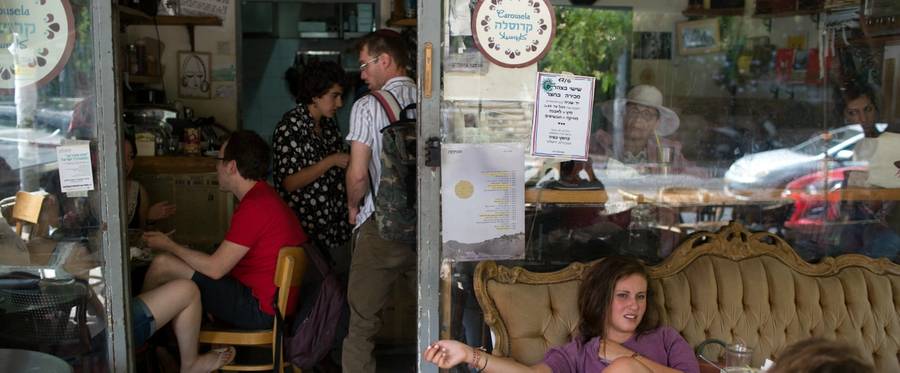 Customers sit at Jerusalem's Carousela restaurant, supervised by "Hashgaha Pratit" (Hebrew for "private supervision"), which certifies that the restaurant abides by kosher practices. June 8, 2016. 