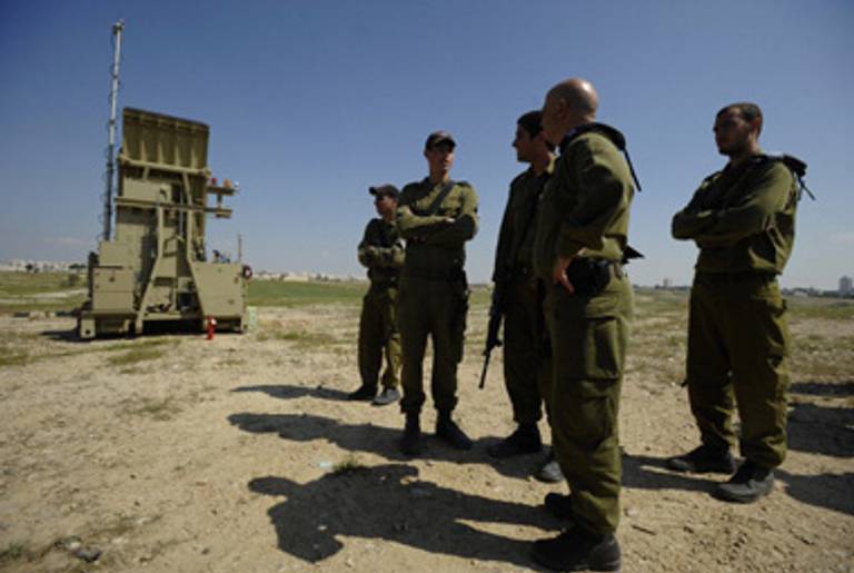 Israeli soldiers in front of an Iron Dome launcher.(David Buimovitch/AFP/Getty Images)