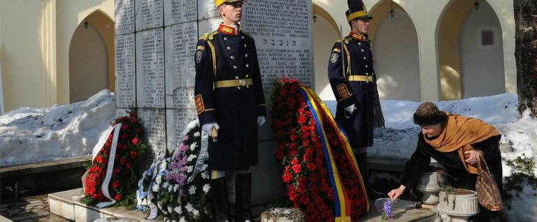 A honor guard soldier stands next to a monument bearing the 768 names of Jews murdered in 1942, when the Struma was torpedoed by a Soviet submarine in the Black Sea, during a ceremony at a Jewish cemetery in Bucharest, Romania, February 24, 2012. 
