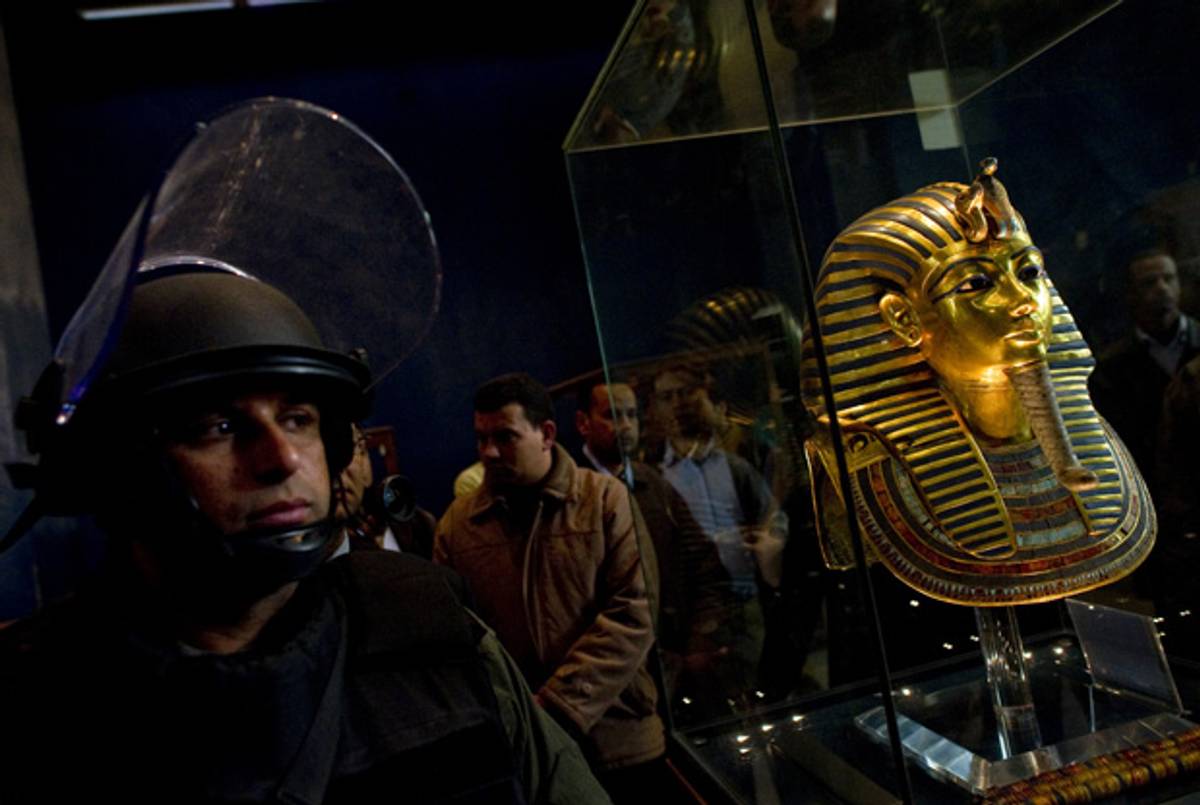 A soldier stands guard next to Tutankhamun's gold funerary mask at the Egyptian Museum on Feb. 16, 2011. Looters broke into the museum in Cairo on Jan. 28, 2011. Tutankhamun's mask was not damaged.(Pedro Ugarte/AFP/Getty Images)