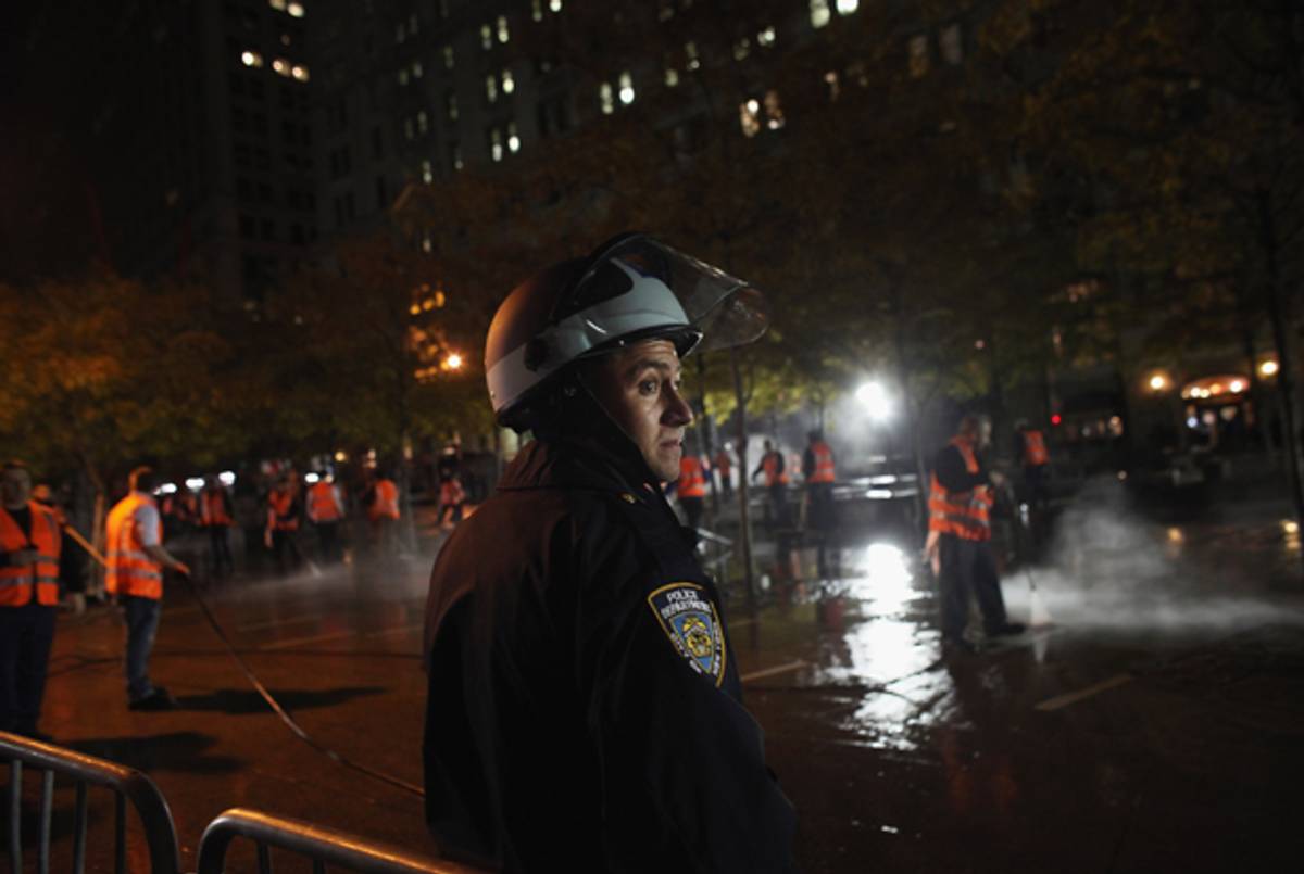 A cleared Zuccotti Park is cleaned as police look on.(Spencer Platt/Getty Images)