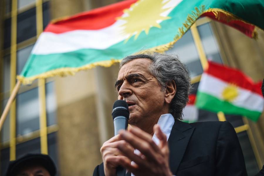 French philosopher Bernard-Henri Lévy addresses people gathered at Paris' Human Rights Plaza on Oct. 12, 2019, during a demonstration to support Kurdish militants