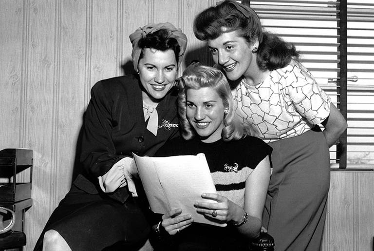 The Andrews Sisters (left to right: Maxene, Patty, and LaVerne) go over a song together on May 7, 1945.(AP)