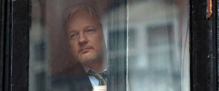 Wikileaks founder Julian Assange prepares to speak from the balcony of the Ecuadorian embassy where he continues to seek asylum following an extradition request from Sweden in 2012, on February 5, 2016 in London, England. 