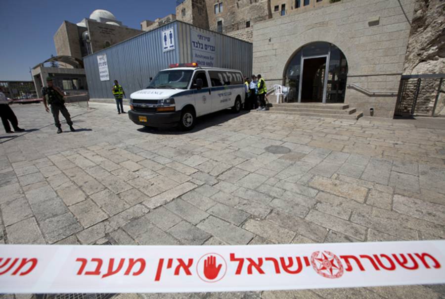 Israeli security forces inspect the area around the Wailing Wall, the holiest site where Jews can pray, in Jerusalem's Old City on June 21, 2013 after an Israeli security guard shot dead a Jewish visitor apparently mistaking him for a Palestinian militant. (AHMAD GHARABLI/AFP/Getty Images)