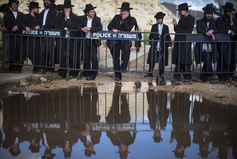  Ultra-Orthodox Jews gather during a protest against their military conscription outside a military prison on December 9, 2013 in Atlit, Israel. (Uriel Sinai/Getty Images)