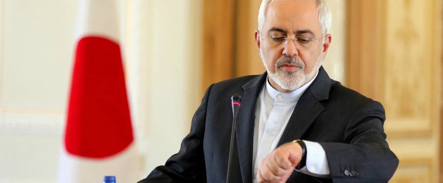 Iranian Foreign Minister Mohammad Javad Zarif looks at his watch during a press conference with his Japanese counterpart, Fumio Kishida, in Tehran, Iran, October 12, 2015 