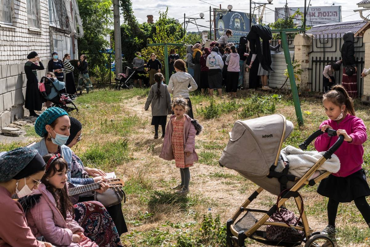 Women and children gather in an area separate from the men, 2020
