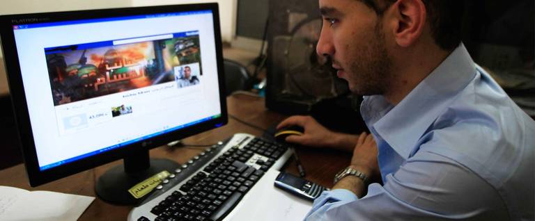 A Palestinian man looks at the Facebook page of Avichay Adraee, the spokesman of the Israeli Army to the Arabic media, after hackers replaced his cover photo with that of the Ezzedine al-Qassam Brigade during the '#Op_Israel' campaign launched by the activist group Anonymous, in Gaza City on April 7, 2013. The hackers reportedly hit several Israeli websites including that of the premier's office, the defence ministry, the education ministry and the Central Bureau of Statistics, among others, but all appeared to be running normally.