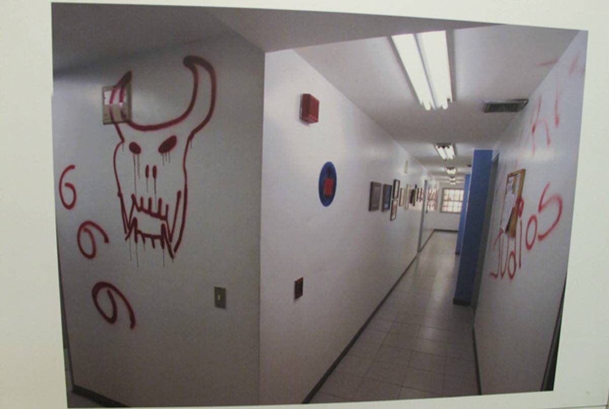 Images of graffiti on the walls of the administrative section of the Mariperez synagogue, part of the exhibit about the Jan. 31, 2009, profanation.