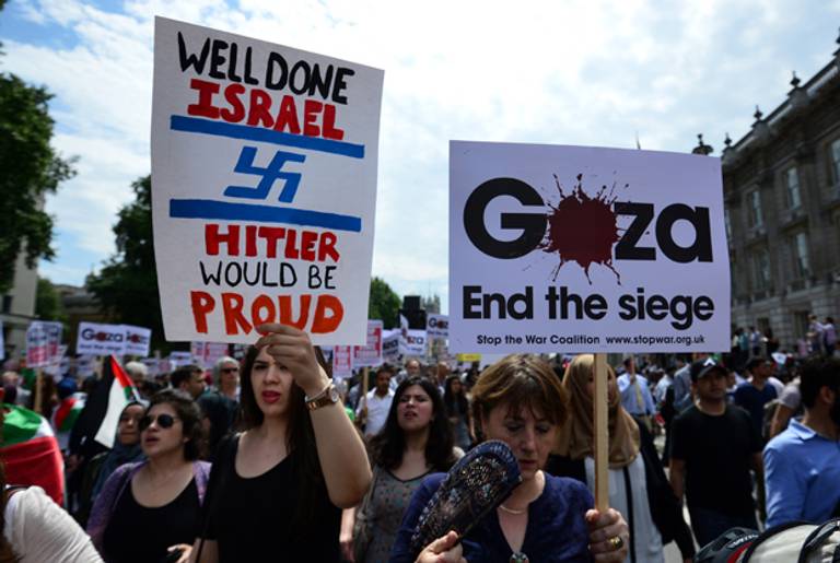 Protesters display placards and banners as they take part in demonstration against Israeli airstrikes in Gaza in central London on July 19, 2014 against Gaza strikes. (CARL COURT/AFP/Getty Images)