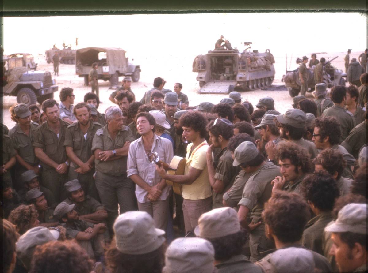 Leonard Cohen performing in the Sinai Desert. Ariel Sharon appears to his left.