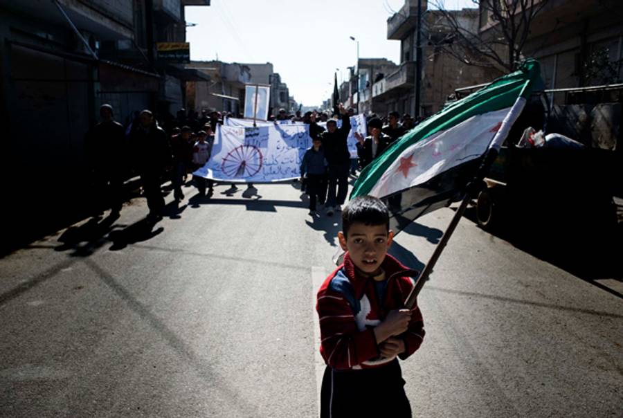 A Syrian boy near Homs carries the rebel flag.(Alessio Romenzi/AFP/Getty Images)