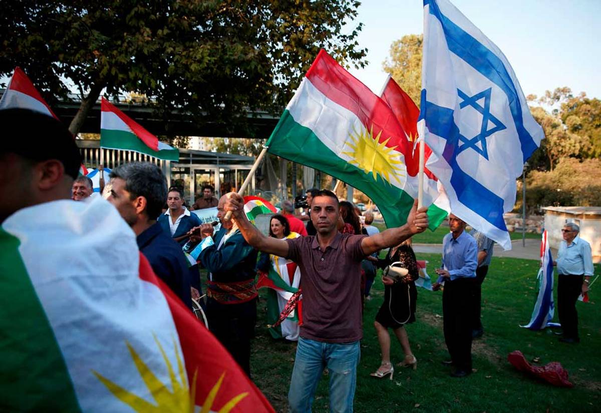 Members of the Kurdish Jewish community hold Kurdish and Israeli flags during a demonstration near the American consulate in Jerusalem on Sept. 24, 2017, in support of the referendum on independence in Iraq’s autonomous Kurdish region, the day before voting polls open. (Photo: Ahmad Gharabli/AFP/Getty Images)